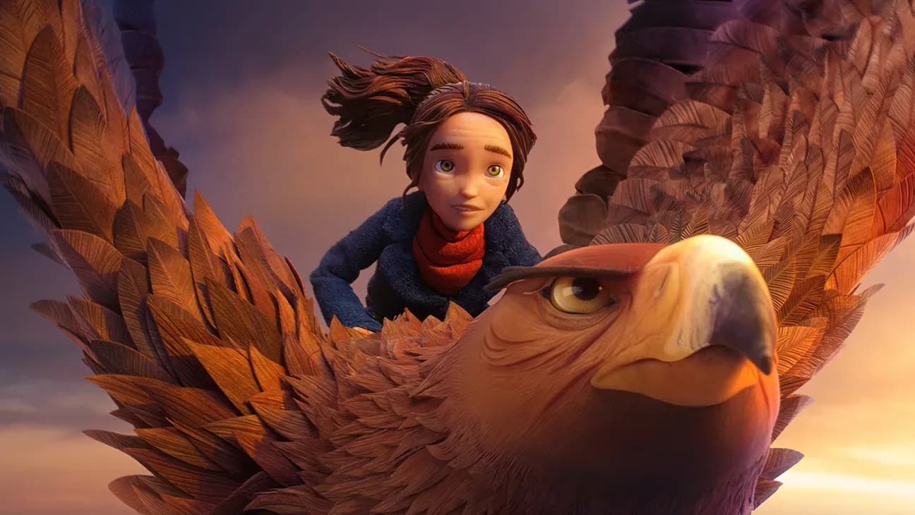 A still from Wildwood showing a young girl standing before a forest of glowing trees, with a crow perched on her shoulder. The sky is dark, but the woods pulse with color.