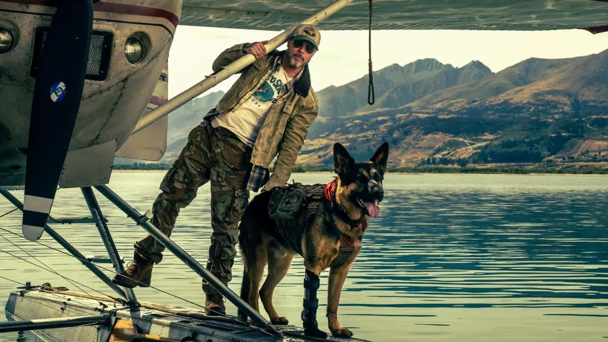 Brad Pitt standing in Alaskan wilderness with his combat dog Odin, promotional poster for Heart of the Beast.
