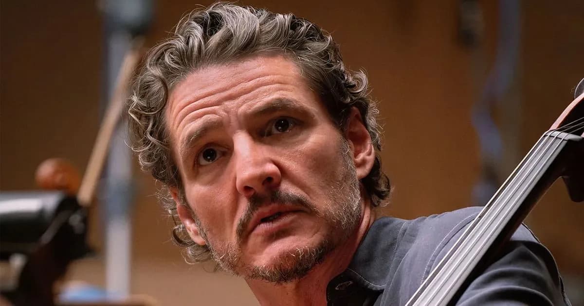 Pedro Pascal in a dimly lit recording studio, bow poised over a cello, eyes closed, lost in thought.