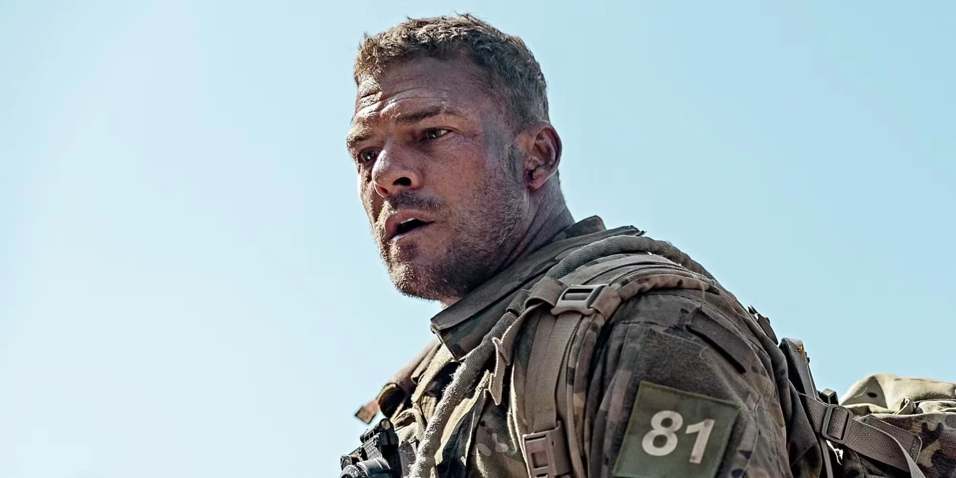 Alan Ritchson in Helldivers promotional still, wearing futuristic armor against alien backdrop