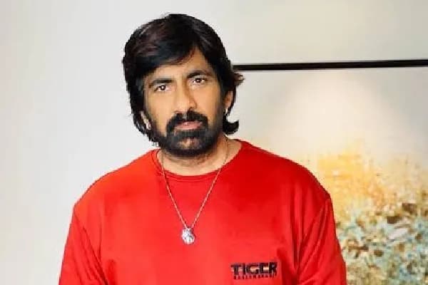 Ravi Teja in a tense expression, standing against a dimly lit backdrop, hinting at a horror theme.
