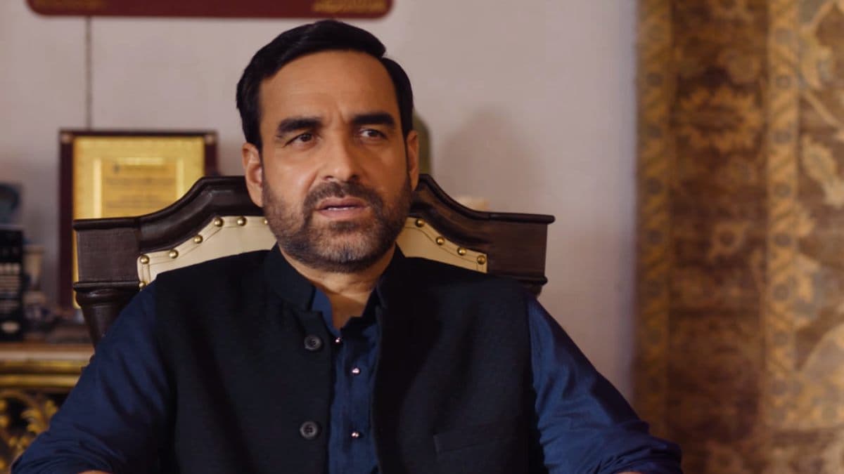 Poster or still from Mirzapur: The Movie featuring the main cast in a tense confrontation