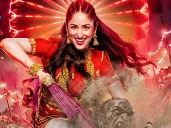 Yami Gautam Dhar in a vibrant traditional outfit, mid-dance, smiling at the camera