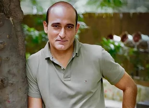 Akshaye Khanna standing in front of his new Malabar Hill apartment building