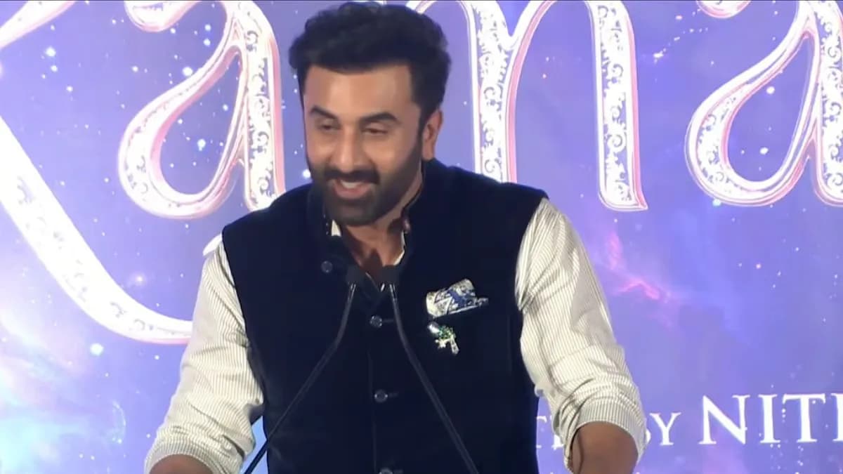 Ranbir Kapoor speaking at the Ramayana trailer launch in Bengaluru, smiling at the audience.
