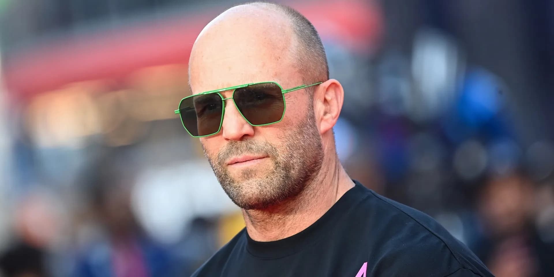 A split image: Jason Statham in a trench coat holding a gun, next to a glowing alien from Disclosure Day