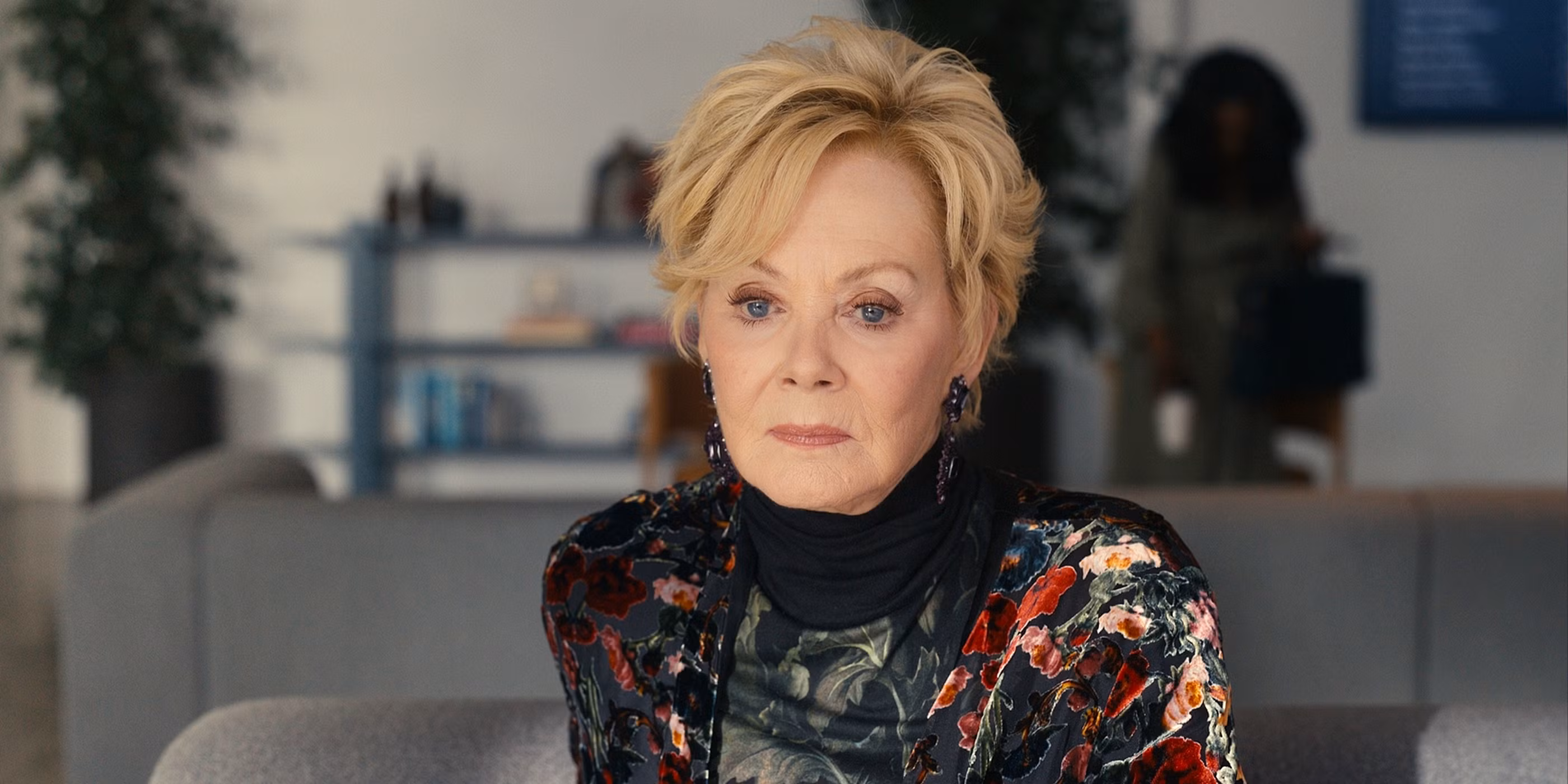 Jean Smart holding an Emmy Award trophy on stage at the Primetime Emmy Awards.