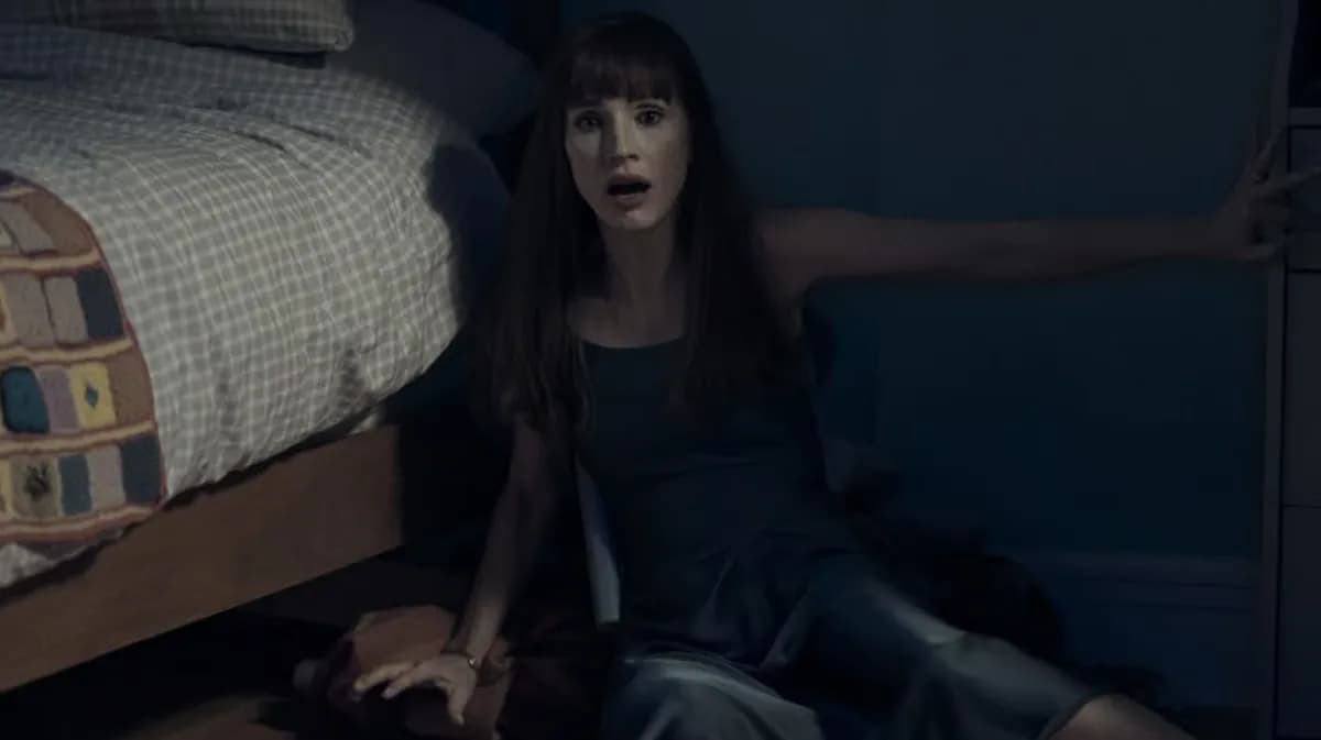 Jessica Chastain in a haunting pose, half-smiling, eyes sharp.
