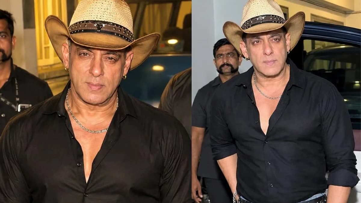Salman Khan in black shirt, jeans and cowboy hat, showing his abs while posing for paparazzi on a street