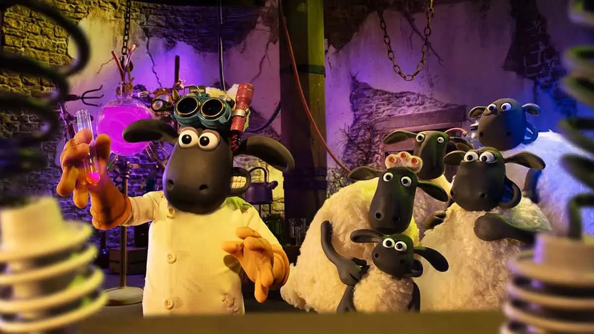 Stop-motion animated characters Shaun the Sheep and Bitzer standing in a pumpkin patch at Mossy Bottom Farm at night