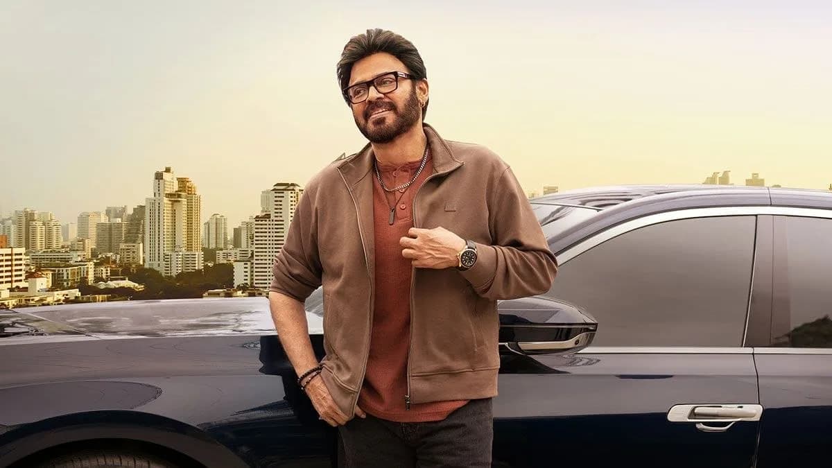 Venkatesh and Trivikram Srinivas standing together on a film set, smiling