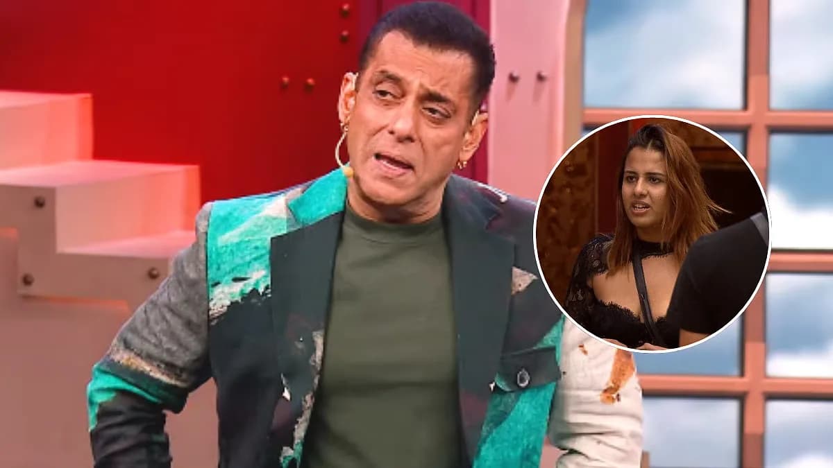 Salman Khan in Bigg Boss 20 promo, mid-sentence, eyes locked on camera, behind him a blurred crowd of contestants reacting