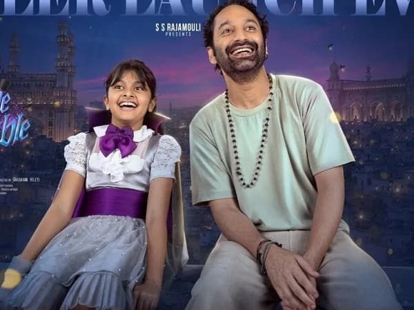 Fahadh Faasil as Suri in the Don't Trouble The Trouble trailer, set against a vibrant fantasy backdrop with colorful village scenery.