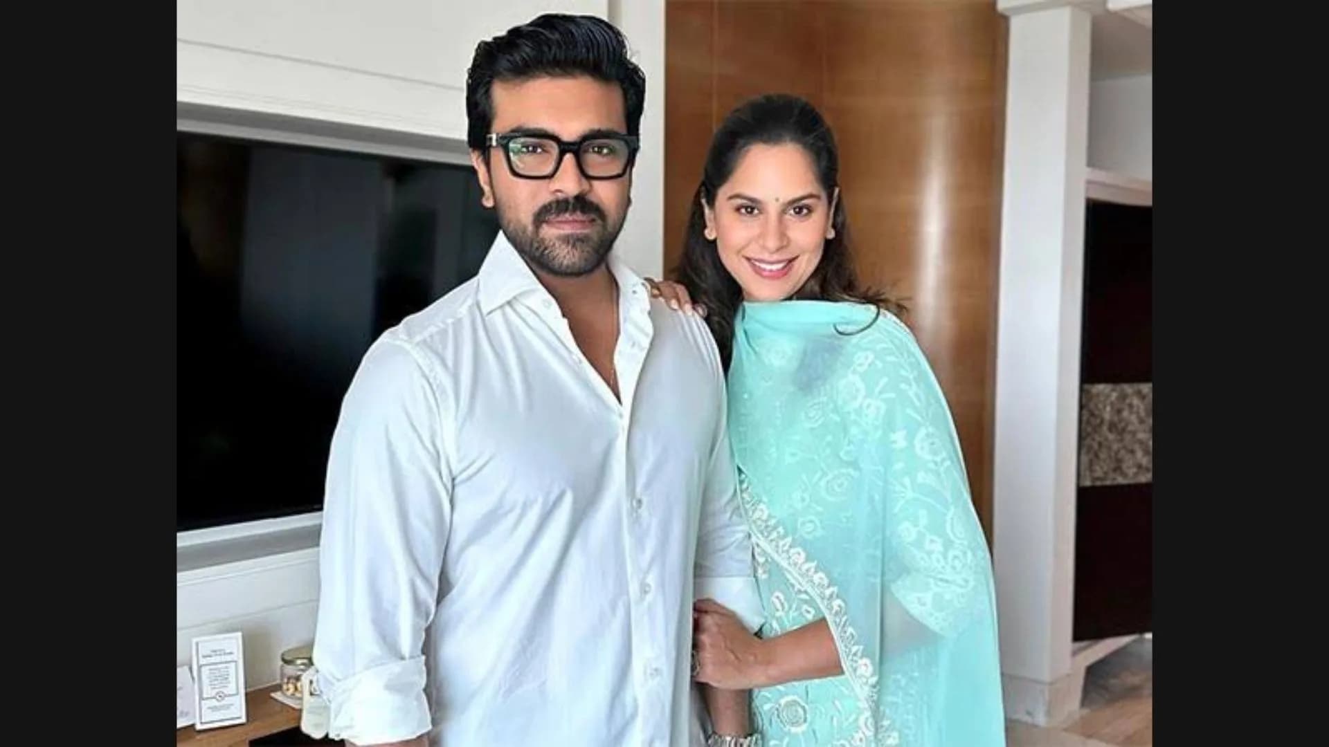Upasana Kamineni Konidela standing beside an Apollo Hospitals sign, wearing a formal blazer