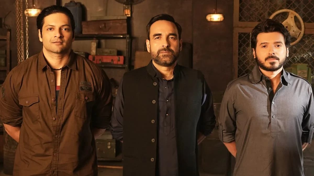 Poster of Mirzapur: The Movie featuring Pankaj Tripathi and Ali Fazal against a gritty city backdrop.