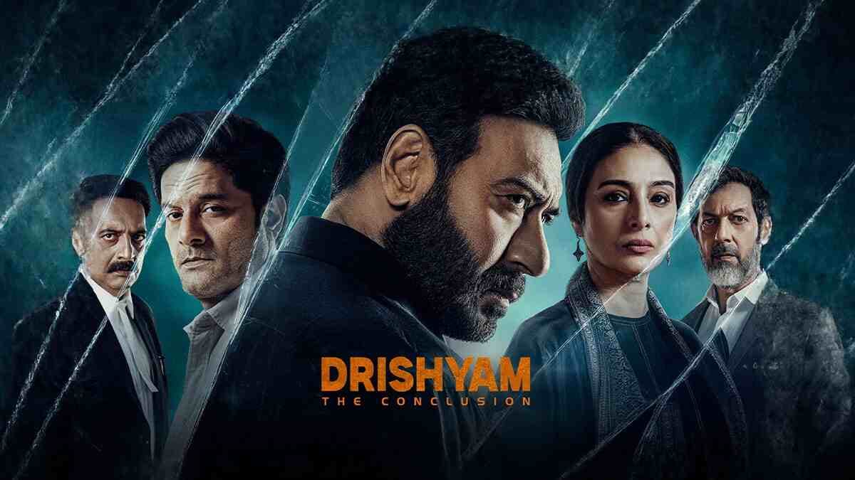 Ajay Devgn in a tense scene from Drishyam: The Conclusion, standing against a dimly lit background with a determined expression.