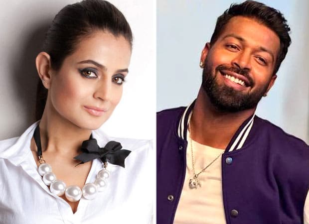 Ameesha Patel smiling with her hand on Hardik Pandya's shoulder during a hotel gathering, screenshot from a viral video