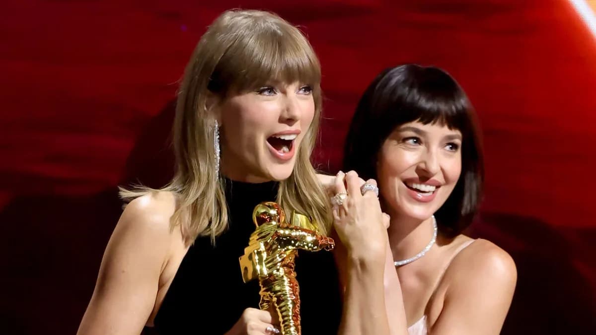 Close‑up of Tom Ford F9 Red lipstick tube next to a still from the Patient Zero music video showing Taylor Swift and Dakota Johnson applying it