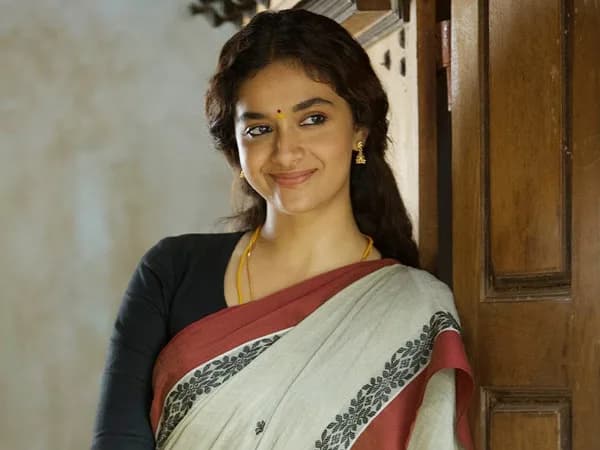 Keerthy Suresh smiling in a behind‑the‑scenes still from the film Dorothy