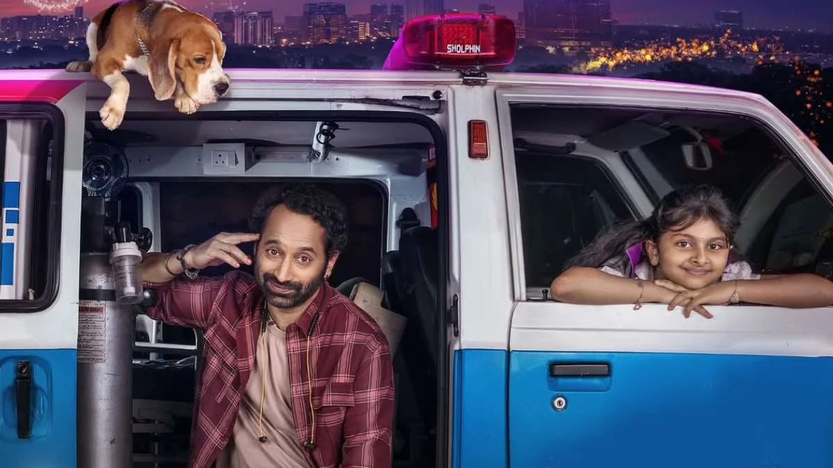 A still from Don’t Trouble The Trouble showing Fahadh Faasil as a dishevelled man holding a child’s hand under a dim streetlight.