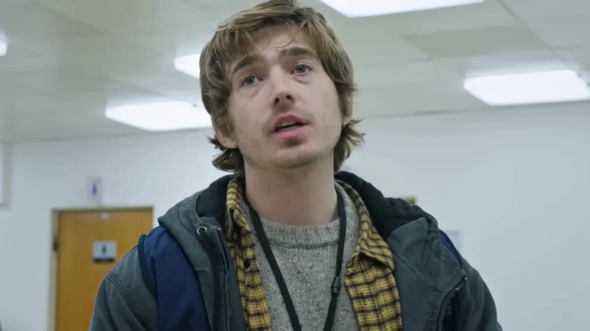 Poster of Resident Evil 2026 reboot featuring Austin Abrams in a dark, rain‑slicked cityscape