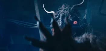 A still from the His Monster trailer showing a man wandering through dark woods at night, from the indie horror film directed by Erich Cannon.