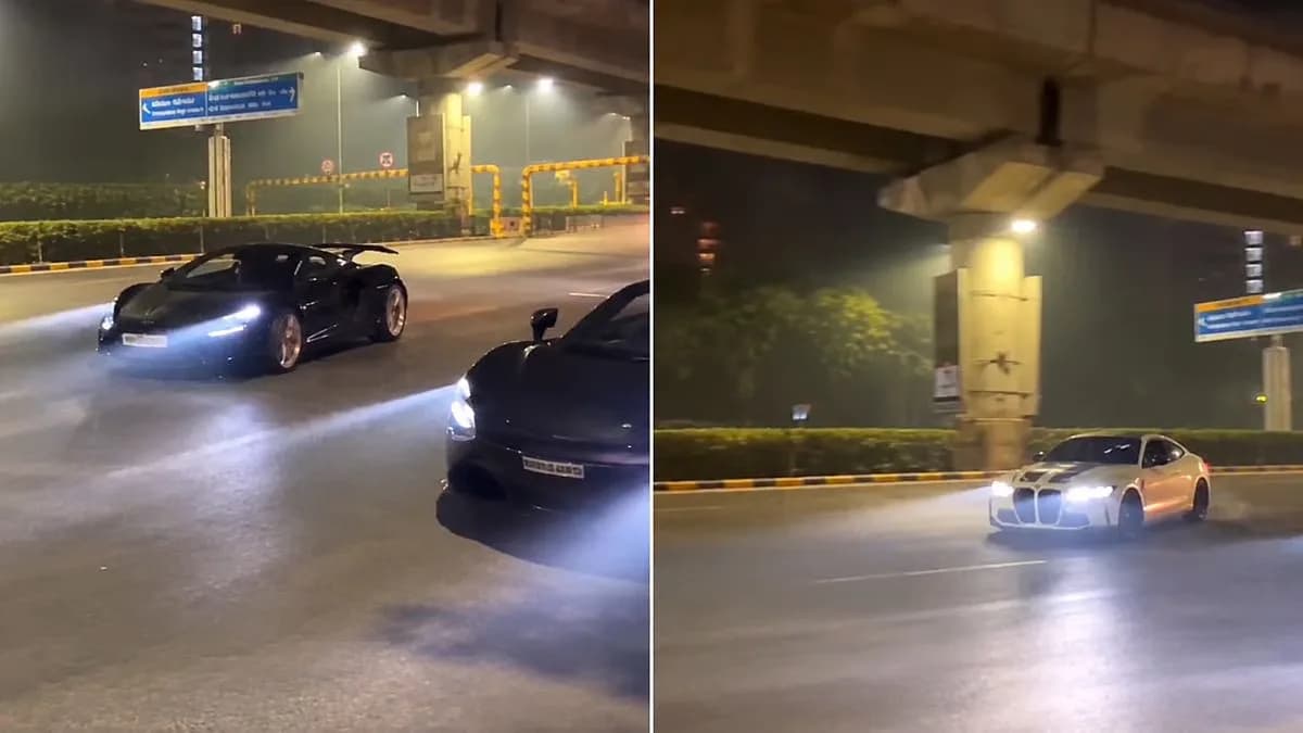 A high-end sports car drifting at speed on a busy multi-lane road with other traffic nearby.