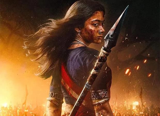 Rashmika Mandanna in Mysaa leading a tribal war, brandishing a spear amidst smoke and fire in the final battle sequence.
