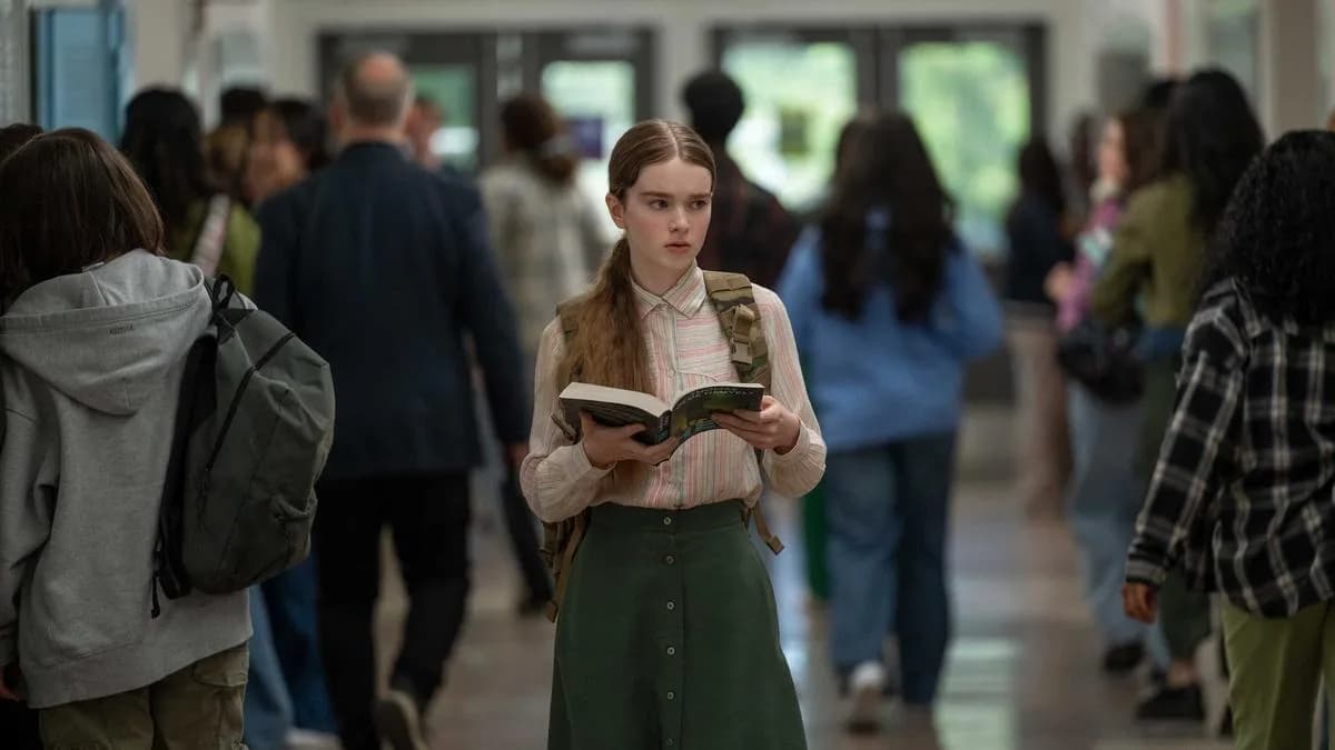 A still from Mike Flanagan’s 'Carrie' series on Prime Video, showing Summer H. Howell as Carrie standing in a dimly lit hallway, looking toward the camera.