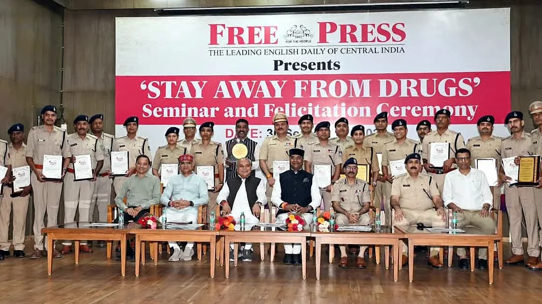 Dignitaries including Narendra Singh Tomar and Vishvas Sarang seated on stage at the Stay Away From Drugs seminar in Bhopal.