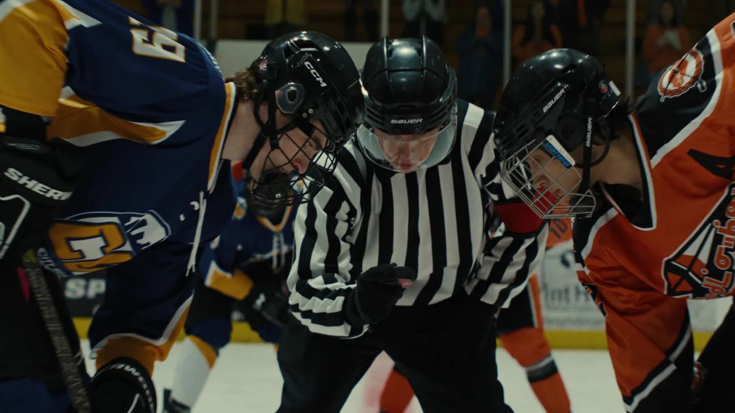 Cody Lightning as Coach Willie on the ice with the Treaty 6 Blades youth hockey team in a still from Smudge the Blades
