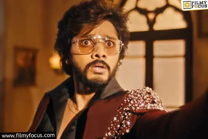 Teja Sajja standing in a dimly lit set, introducing The Traitors Telugu in a promotional video
