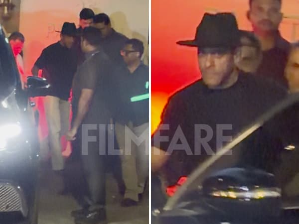 Salman Khan in a black T-shirt and black cap waving at photographers while arriving at Ahaan Panday's residence.