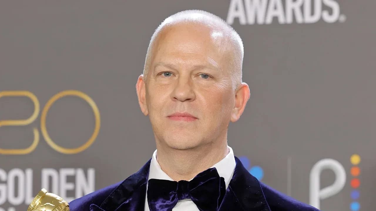 Ryan Murphy speaking to press on a red carpet at a television industry event.