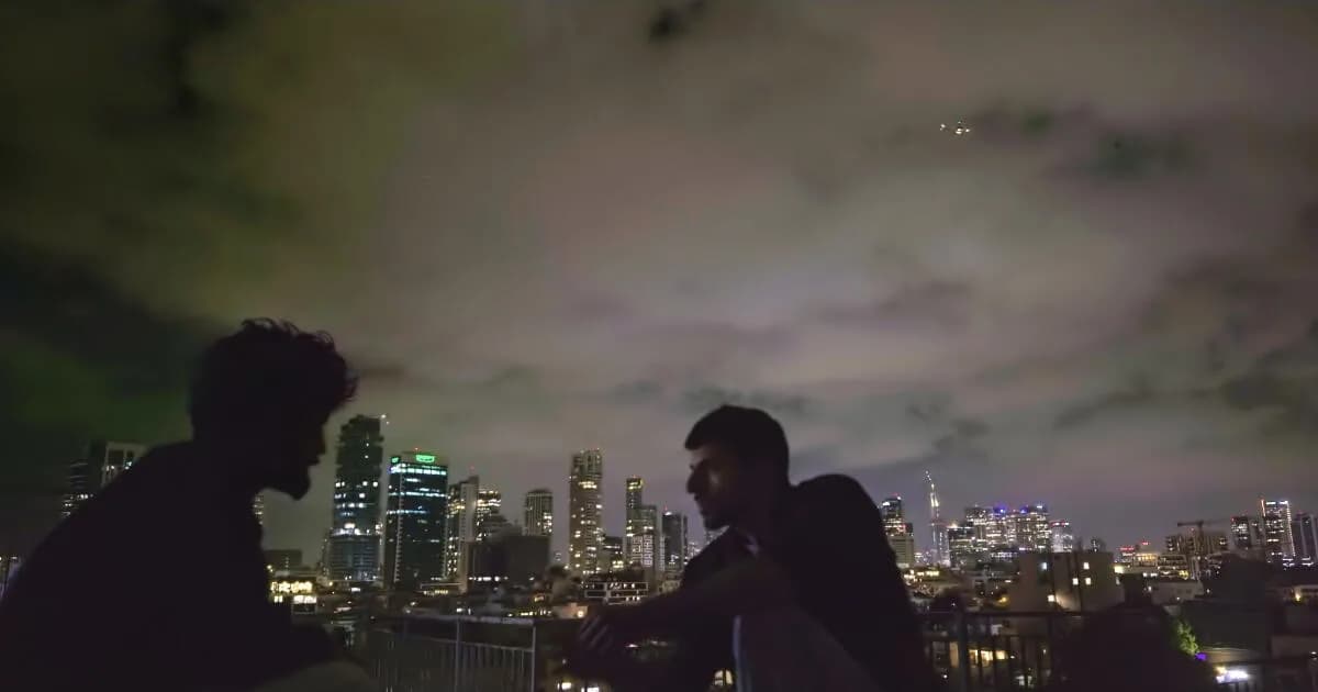 Silhouetted figures against a lit Tel Aviv skyline, blurred faces, dark windows.