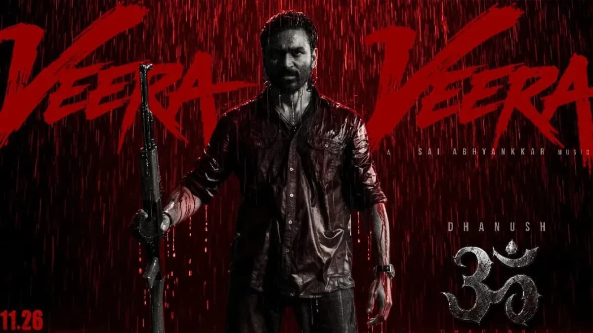 Dhanush and Mammootty standing in a dramatic forest scene, silhouetted against a blood-red sky