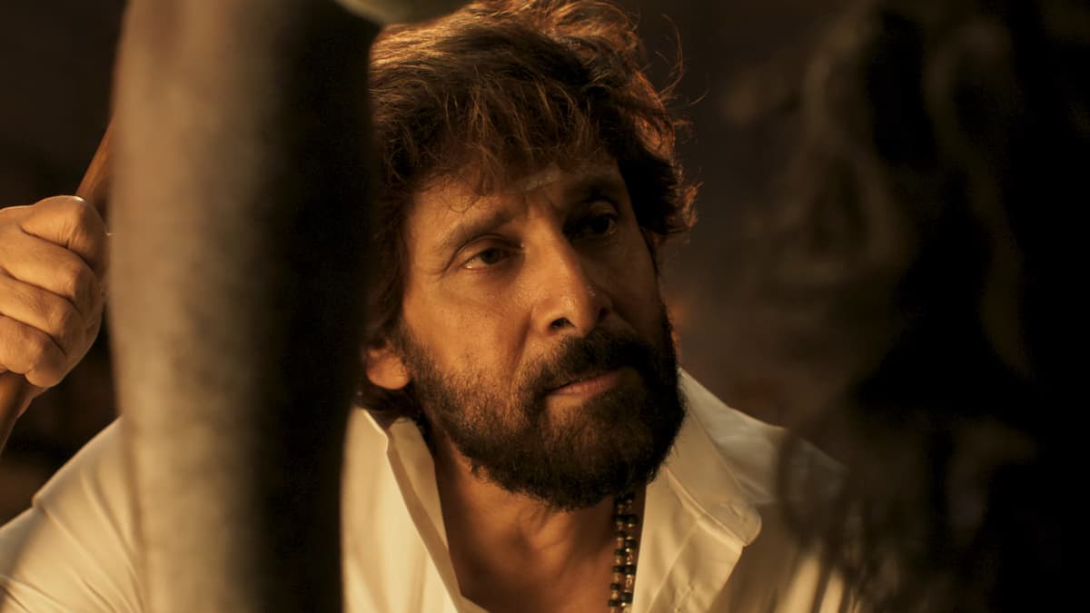 Tamil actor Vikram in a still from the Power House title teaser, standing in a dimly lit room