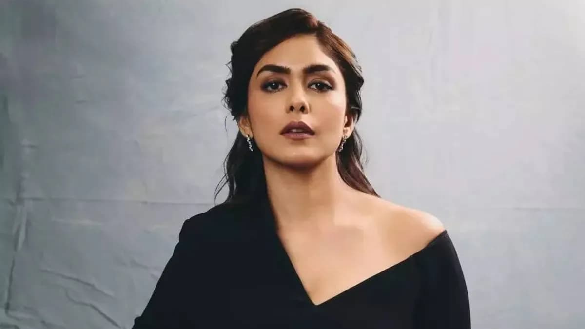 Mrunal Thakur in a simple white outfit, looking directly at the camera with calm focus.