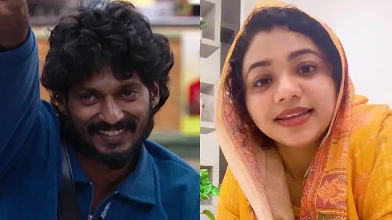 Shijin S on his knees, head bowed, reaching toward Nowfina Sabu's feet in a dramatic apology scene from Bigg Boss Malayalam 8