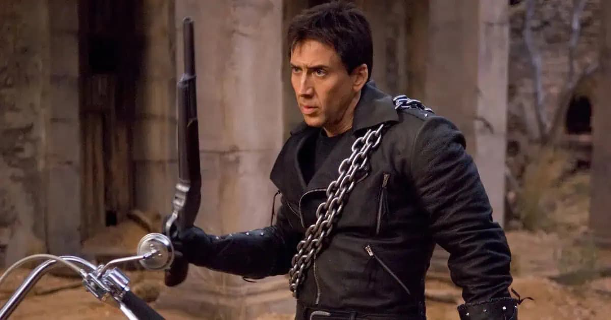 Nicolas Cage at Fan Expo Dallas, mid-speech, holding a microphone, looking intense.