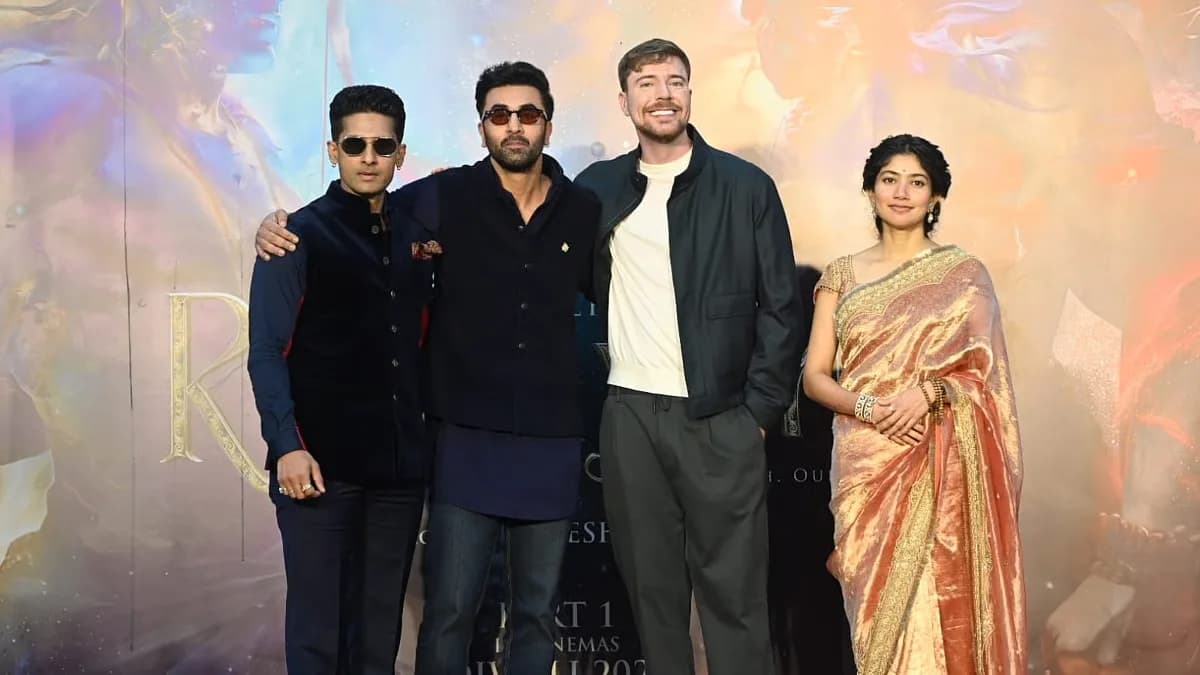 MrBeast on stage beside Ranbir Kapoor at the Ramayana pre‑release event, microphone in hand, audience clapping