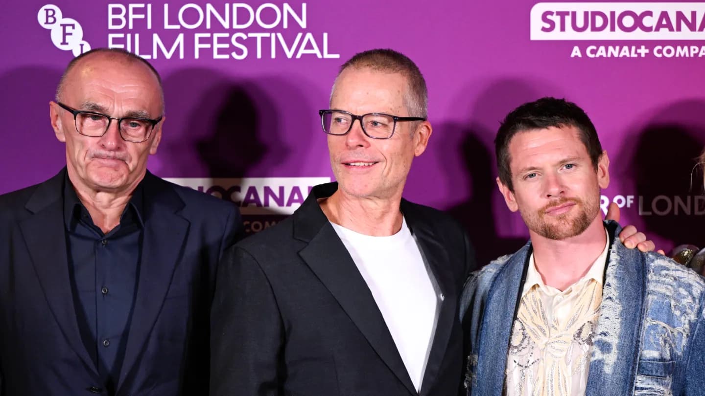 Jack O’Connell and Guy Pearce on the red carpet at the BFI London Film Festival, standing under a banner that reads 'Ink'.