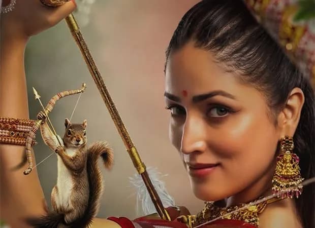 Yami Gautam Dhar in a traditional red-and-gold ensemble, eyes closed, as a chorus of voices swirl around her in a golden haze.