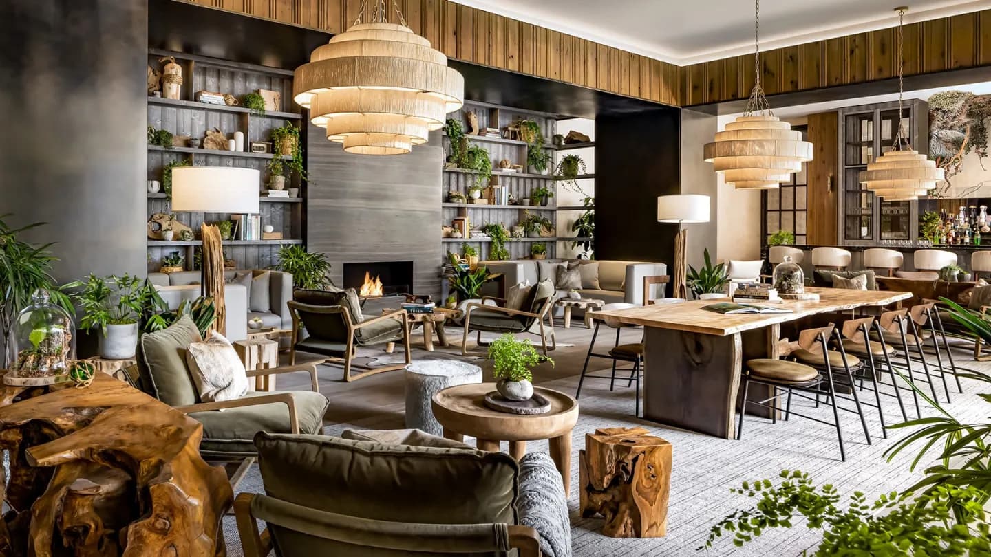 An elegant hotel lobby in Toronto with a cocktail bar and guests gathered during TIFF, featuring modern architecture and warm lighting.
