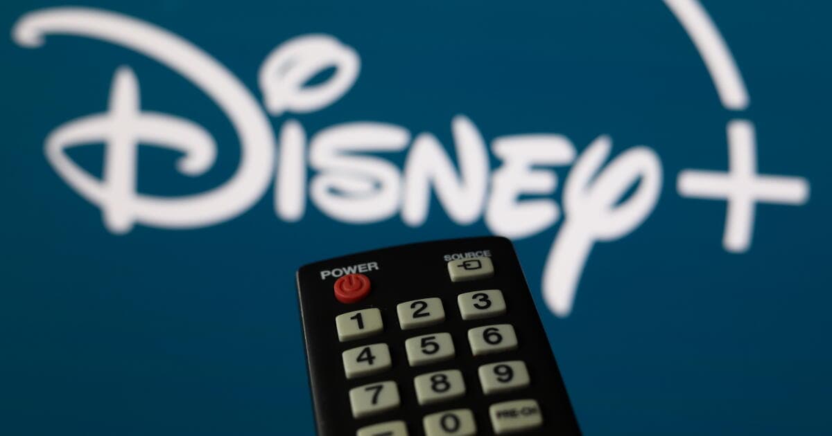 Disney+ app interface displayed on a smartphone screen alongside the Disney logo