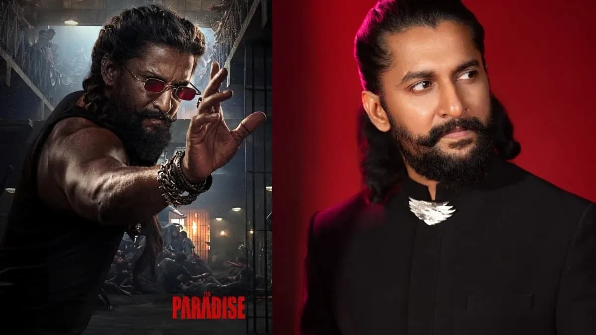 Nani standing on a film set with a backdrop of the movie’s poster, smiling at the camera.