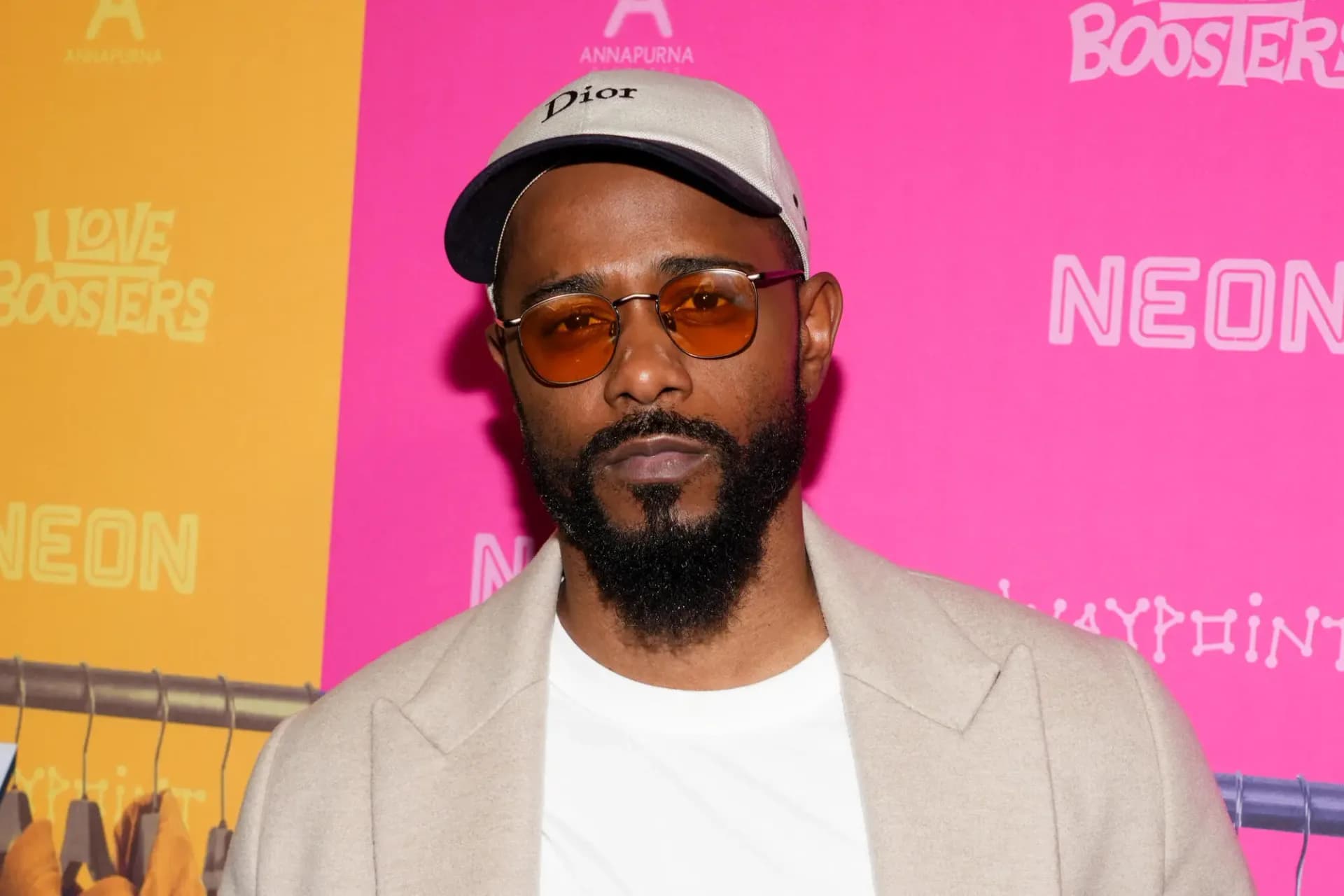 LaKeith Stanfield at New York Comic-Con, holding a prop tunnel door.