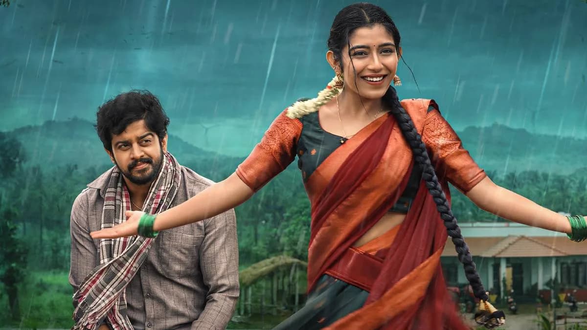 A still from Premada Oorali showing the lead pair in a romantic moment against a rural backdrop.