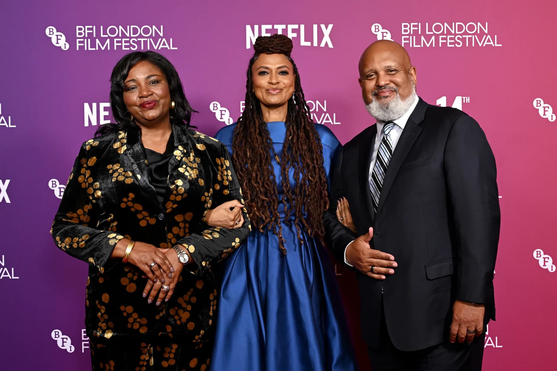 Ava DuVernay at the London Film Festival stage, holding a microphone, surrounded by audience members applauding.