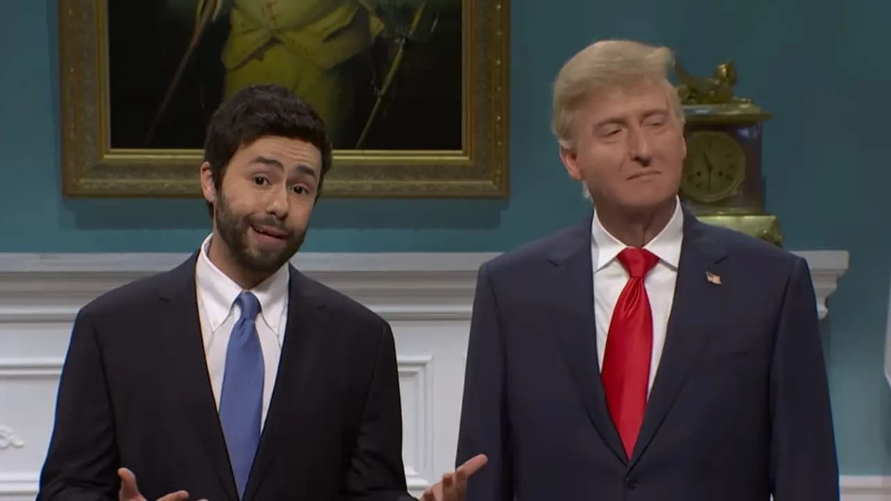 James Austin Johnson as Donald Trump in a SNL cold open, standing beside Ramy Youssef as Zohran Mamdani, both smiling unnervingly.
